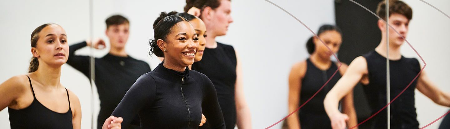 Group of people smiling and dancing during a class at CitySport studio.