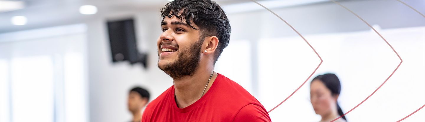 Man smiling during a group fitness class at CitySport gym.