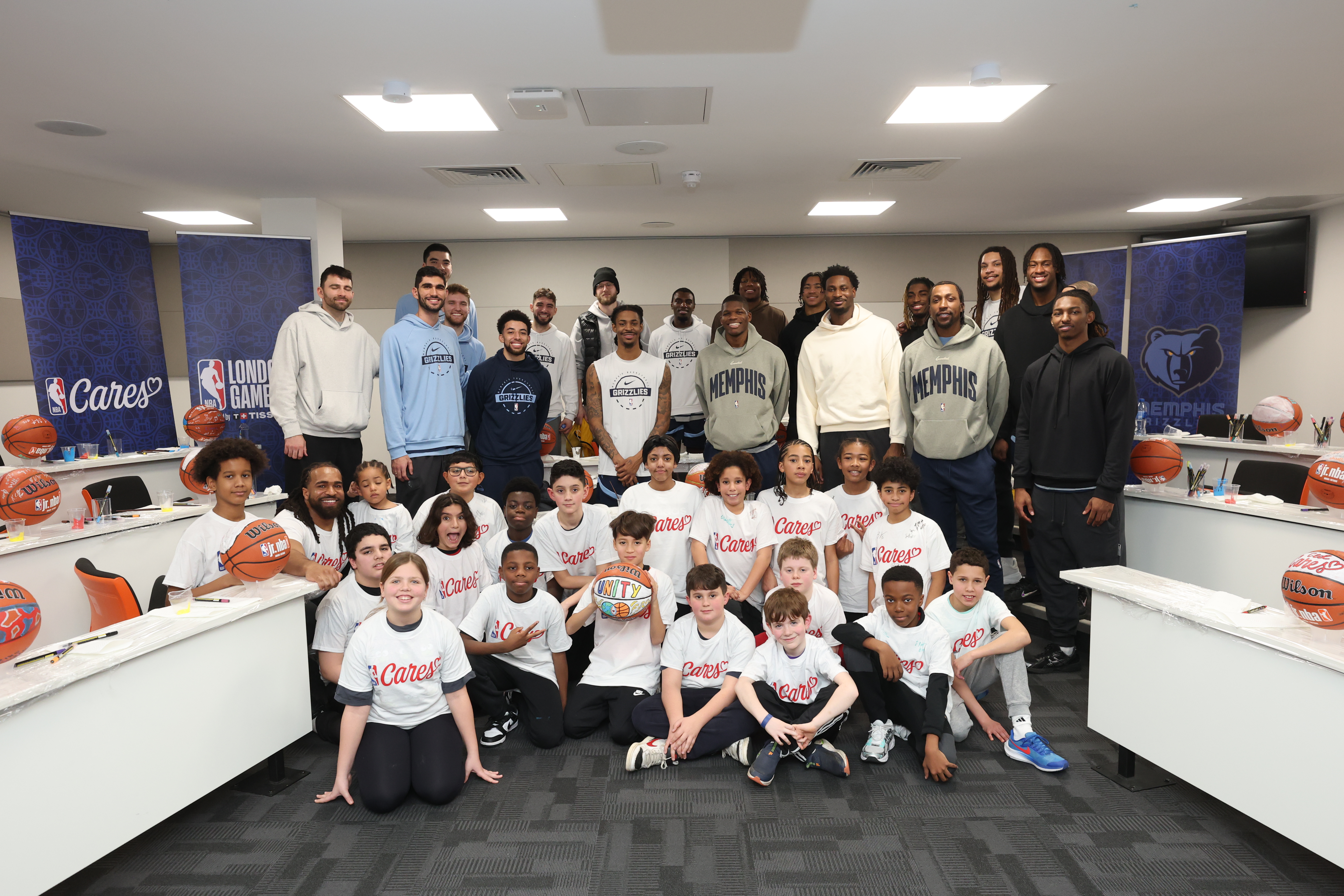 The Memphis Grizzlies Basketball team with local London chidlren in a small lecture room