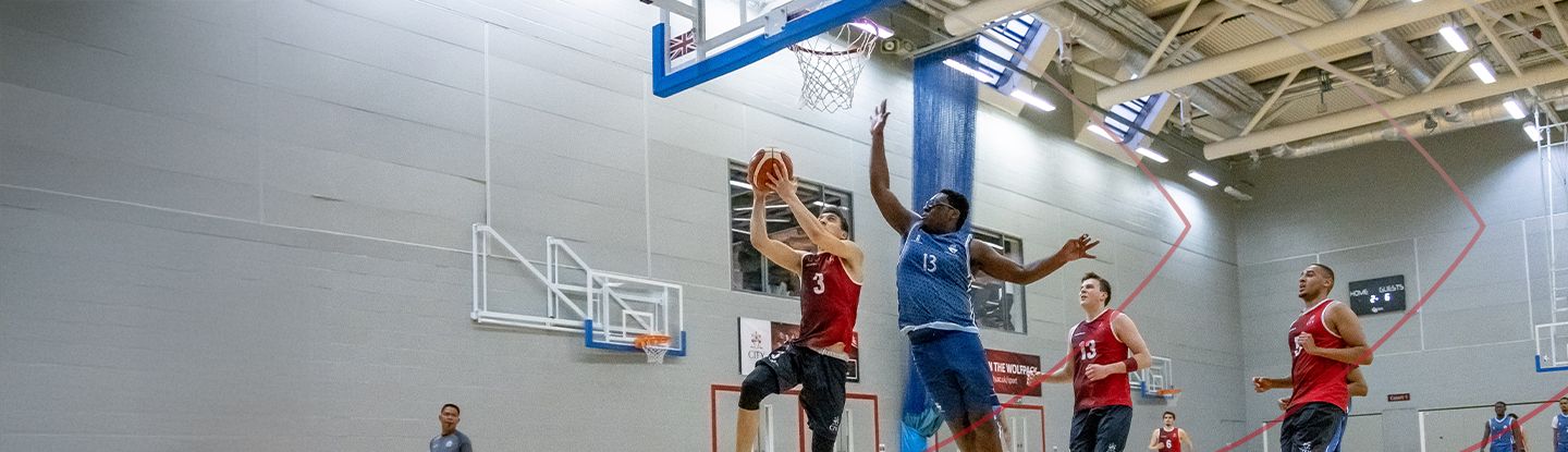 Basketball players in action during a game at CitySport sports hall.